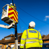 Engineer In A Cherry Picker Working On An Electricity Pole Engineer In A Cherry Picker Working On An Electricity Pole